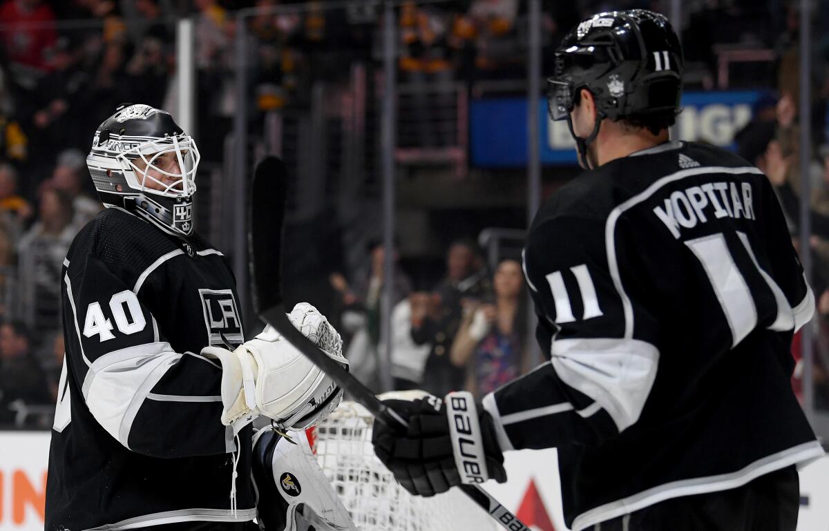 Kings' Calvin Petersen, left, celebrates a 2-1 win over the Pittsburgh Penguins with Anze Kopitar at Staples Center on Wednesday.