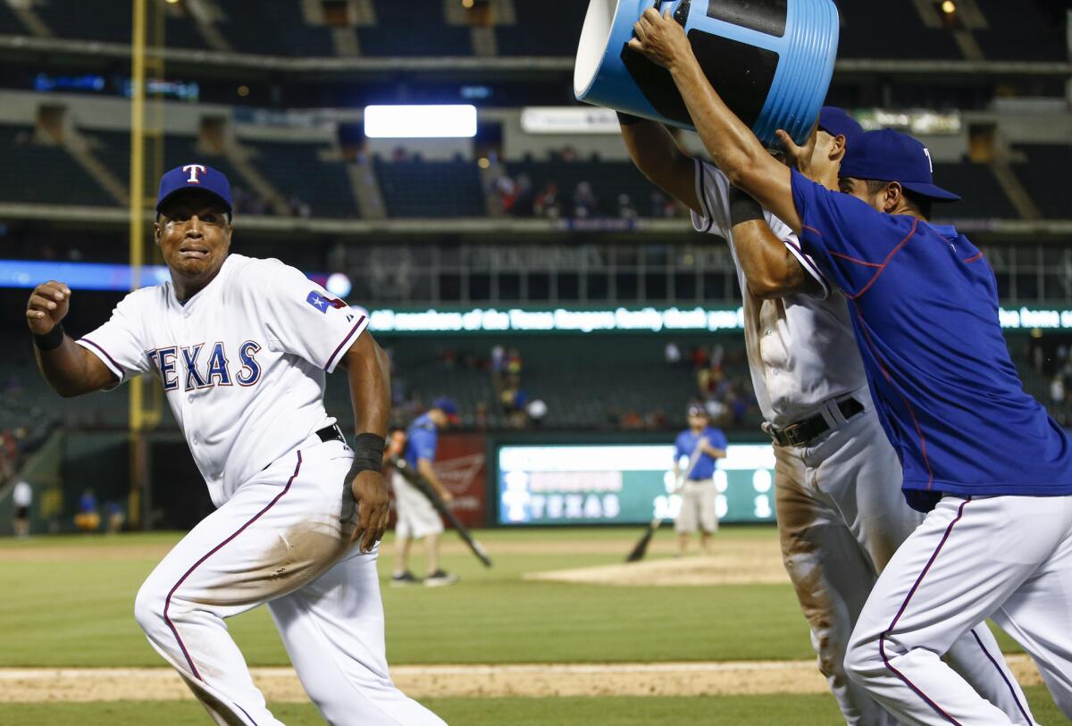 Texas' Adrian Beltre is chased by Rougned Odor, center, and Martin Perez after hitting for the cycle during the Rangers' 12-9 win over Houston on Monday.