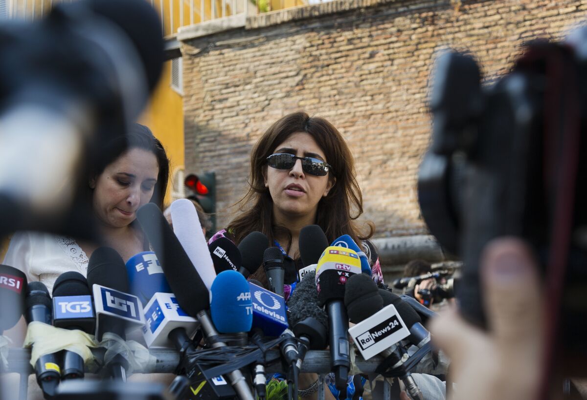 FILE - Italian communications expert Francesca Chaouqui talks to journalists July 7, 2016, after a Vatican court convicted her and a Vatican monsignor for having conspired to pass documents to two Italian journalist. A Vatican trial into a money-losing investment has been jolted by revelations that a key prosecution witness was apparently manipulated into changing his story and cooperating with prosecutors. (AP Photo/Domenico Stinellis, File)