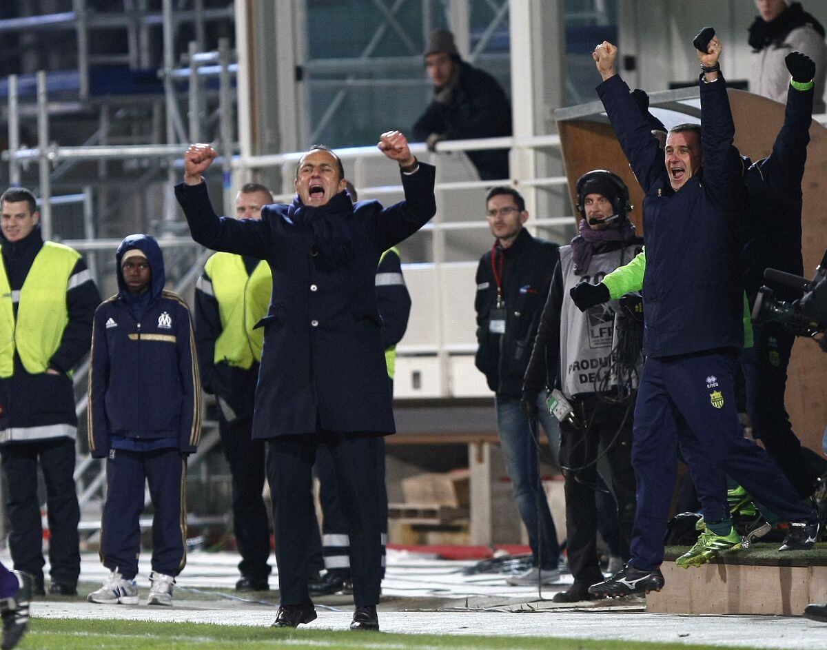 FILE - Nantes' French coach Michel Der Zakarian, centre, reacts with Nantes' team members, after defeating Marseille, at the end of their League One soccer match at the Velodrome Stadium, in Marseille, southern France, Friday, Dec. 6, 2013. When Michel Der Zakarian was appointed as Montpellier head coach following the sacking of Romain Pitau, the southern club was just two points clear of the relegation zone. Since his return at the Stade de La Mosson, Montpellier is unbeaten, winning five of the six league games it has played. (AP Photo/Claude Paris, File)