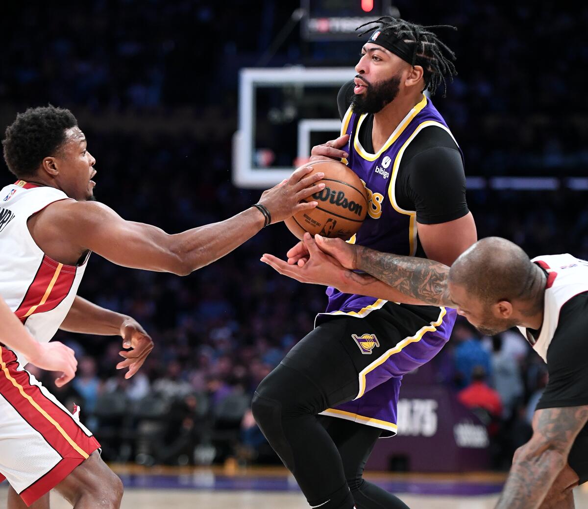 Lakers forward Anthony Davis drives against Miami's Kyle Lowry, left, and P.J. Tucker.