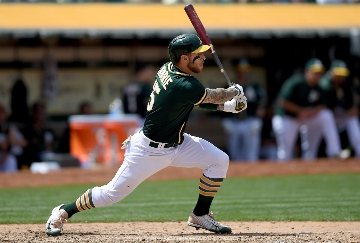 Oakland third baseman Brett Lawrie drives in a run with a double off of Jered Weaver in the bottom of the sixth inning. The Angels lost to the Athletics, 4-1.