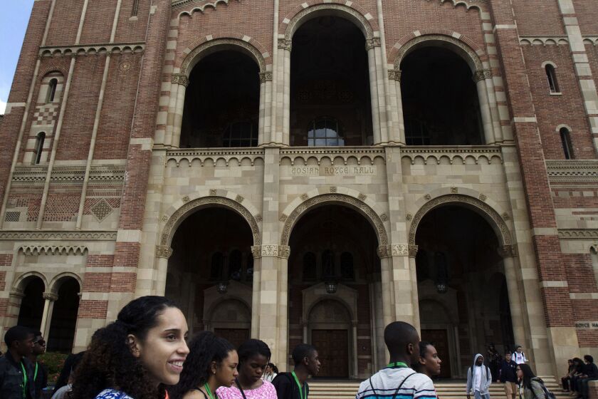 Prospective students touring the UCLA campus on April 8 pass Royce Hall.