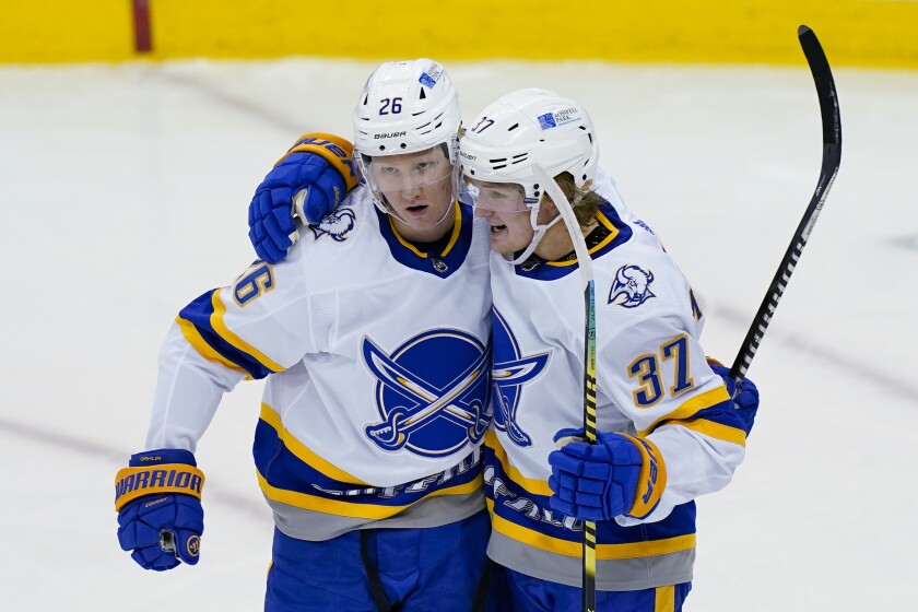 Buffalo Sabres center Casey Mittelstadt (37) celebrates his goal against the New Jersey Devils with defenseman Rasmus Dahlin (26) during the third period of an NHL hockey game Tuesday, April 6, 2021, in Newark, N.J. (AP Photo/John Minchillo)