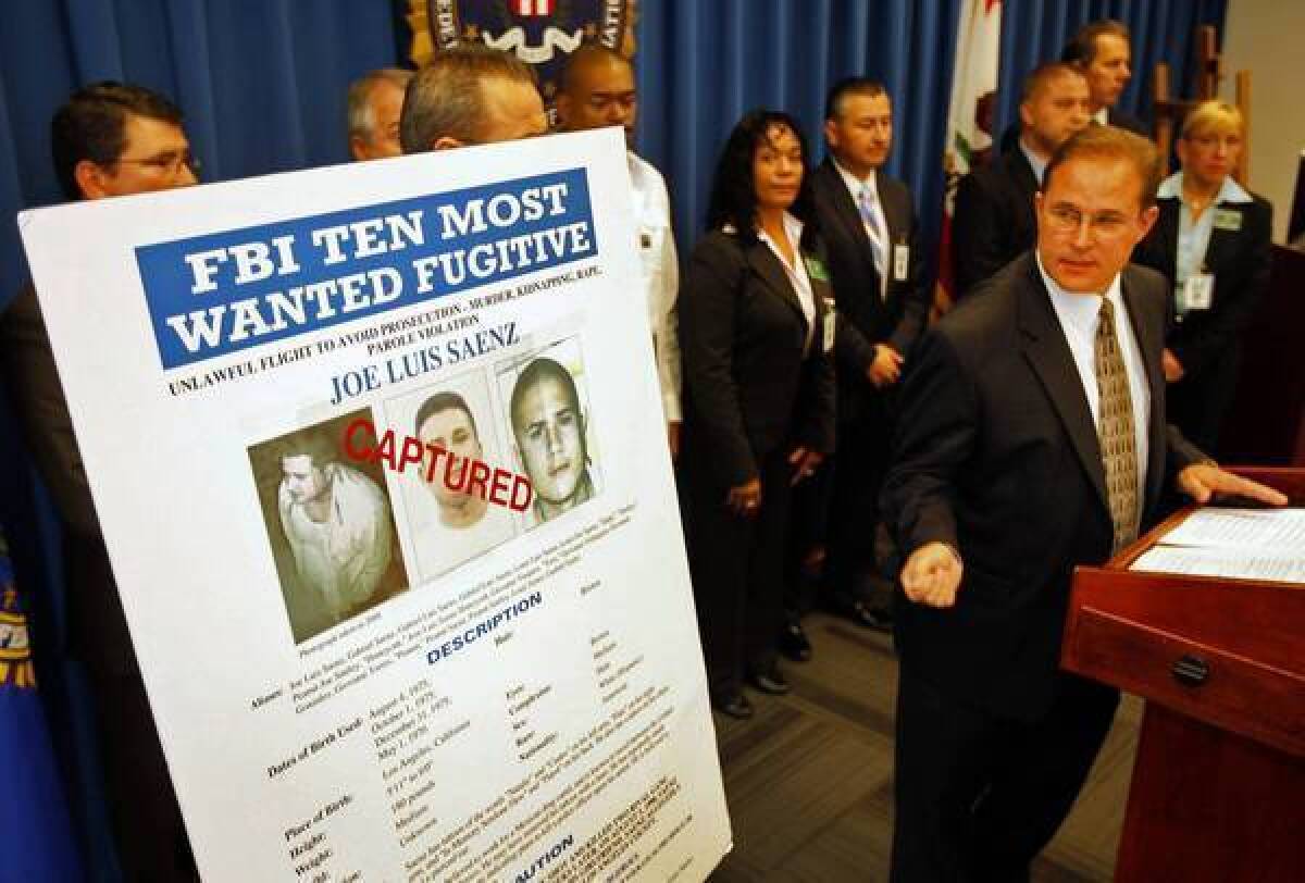 Bill Lewis, right, of the FBI's Los Angeles office speaks at a news conference about the arrest of Jose Luis Saenz.