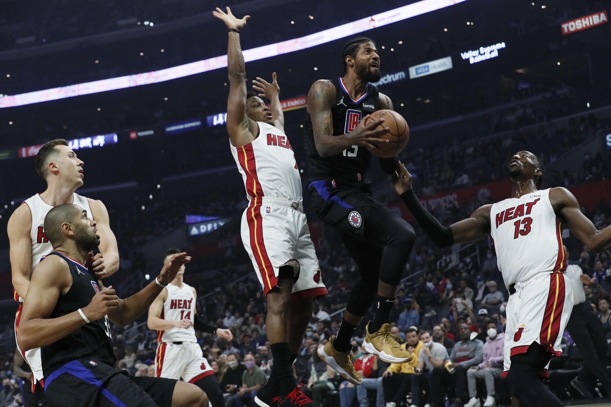 Clippers forward Paul George drive for a layup against the Heat.