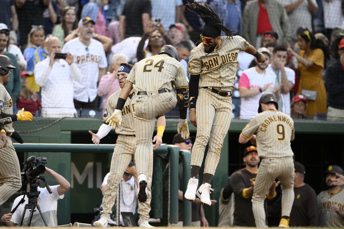 The Padres' Rougned Odor (24) celebrates his three-run homer with Fernando Tatis Jr. 