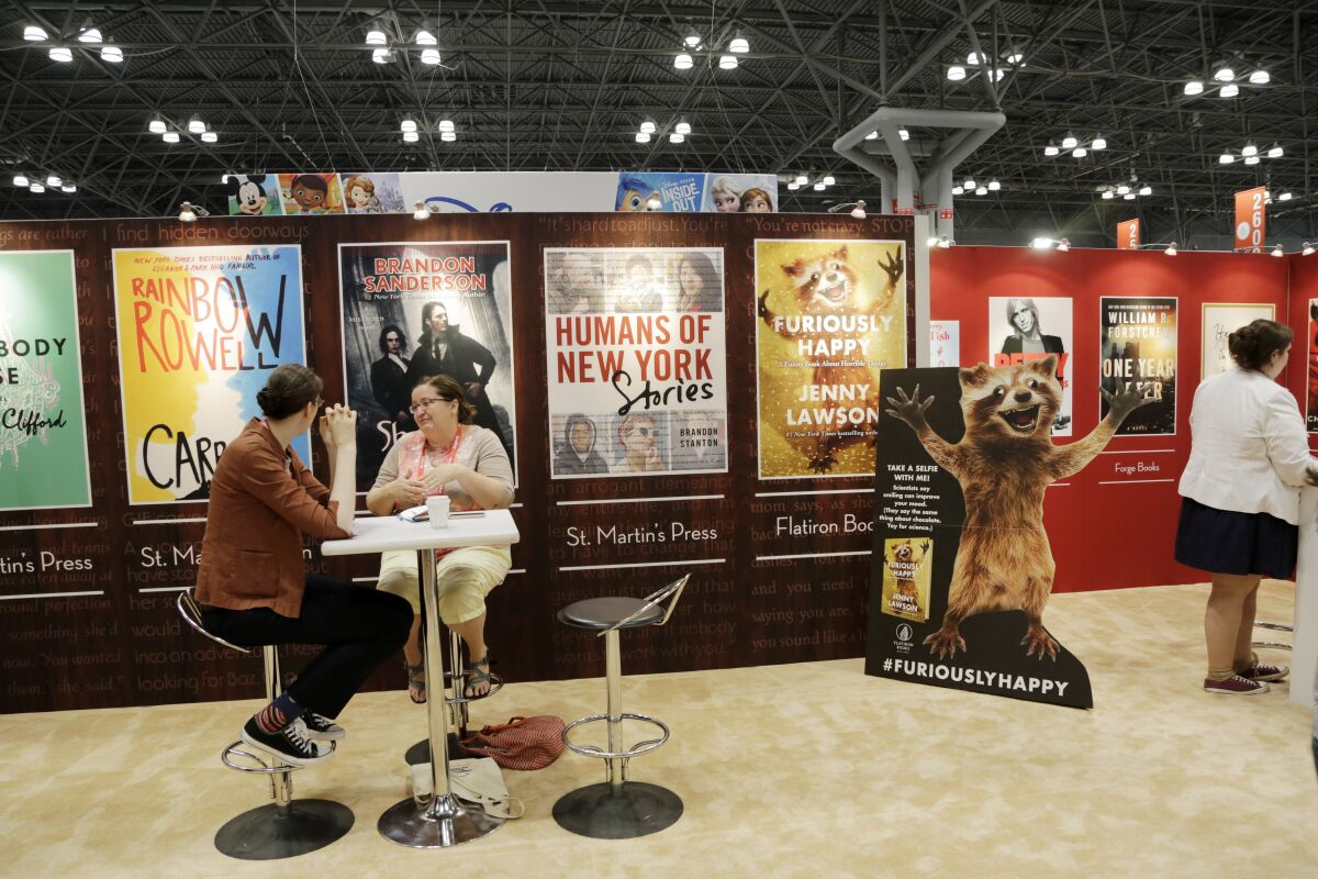 BookExpo America attendees visit the Macmillan booth in 2015, in New York. 