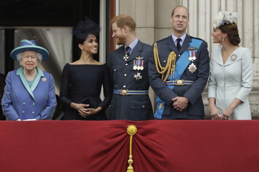 Queen Elizabeth II stands with Meghan the Duchess of Sussex, Prince Harry, Prince William and Kate the Duchess of Cambridge.