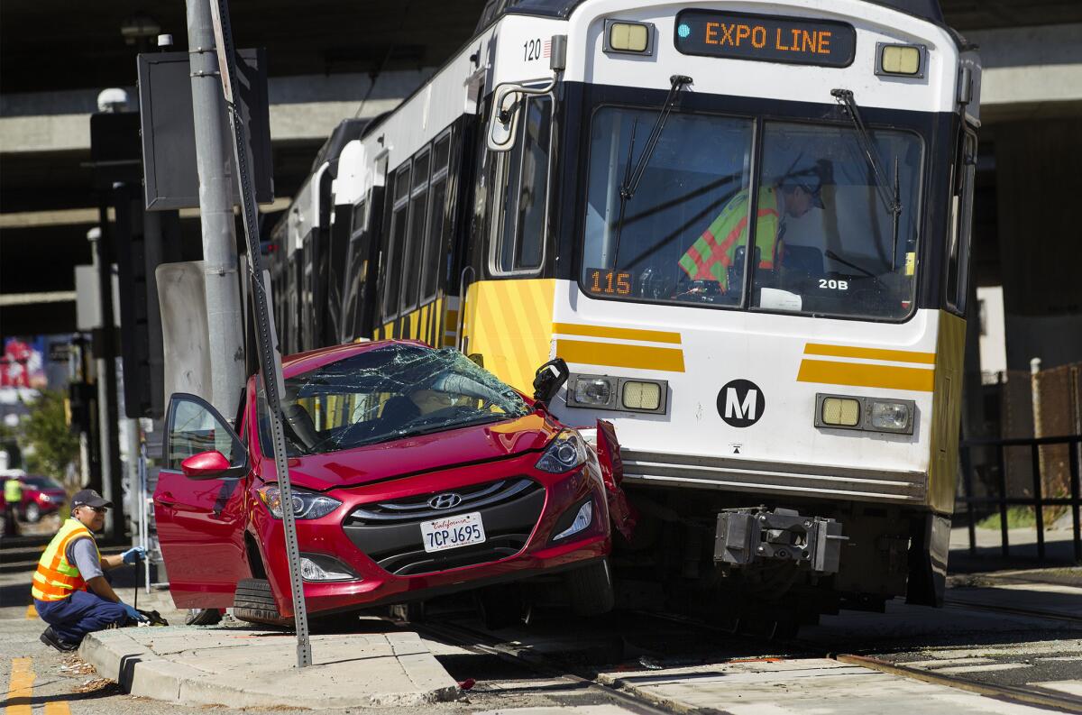 A Metro Expo Line train collided with a car knocking the front of the train off the tracks.