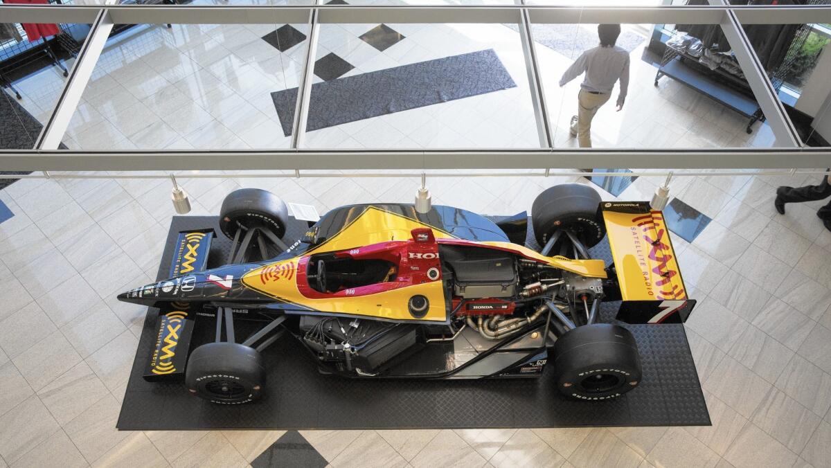 An Indy race car is displayed in the lobby of Honda Performance Development.