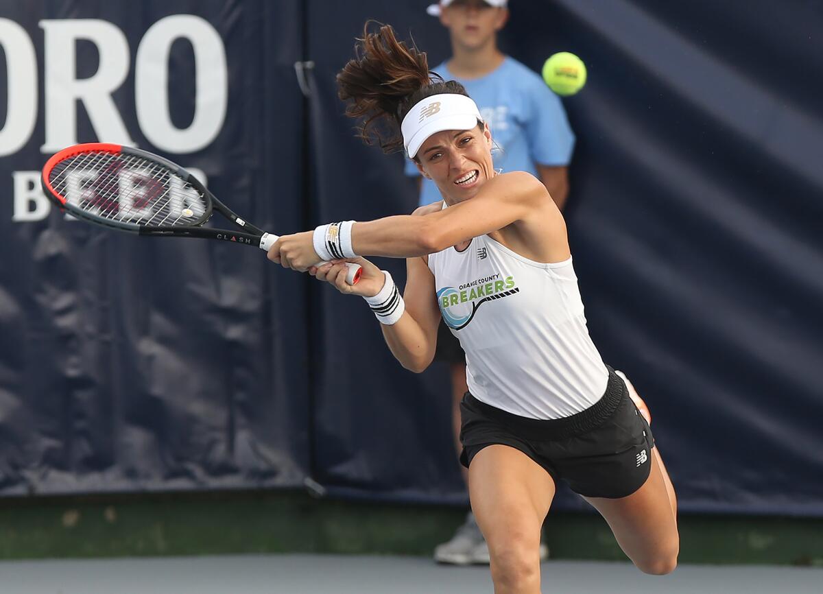 Nicole Gibbs of the Orange County Breakers rips a backhand winner in a women's doubles match against the New York Empire in a World Team Tennis match on Wednesday at Palisades Tennis Club in Newport Beach.