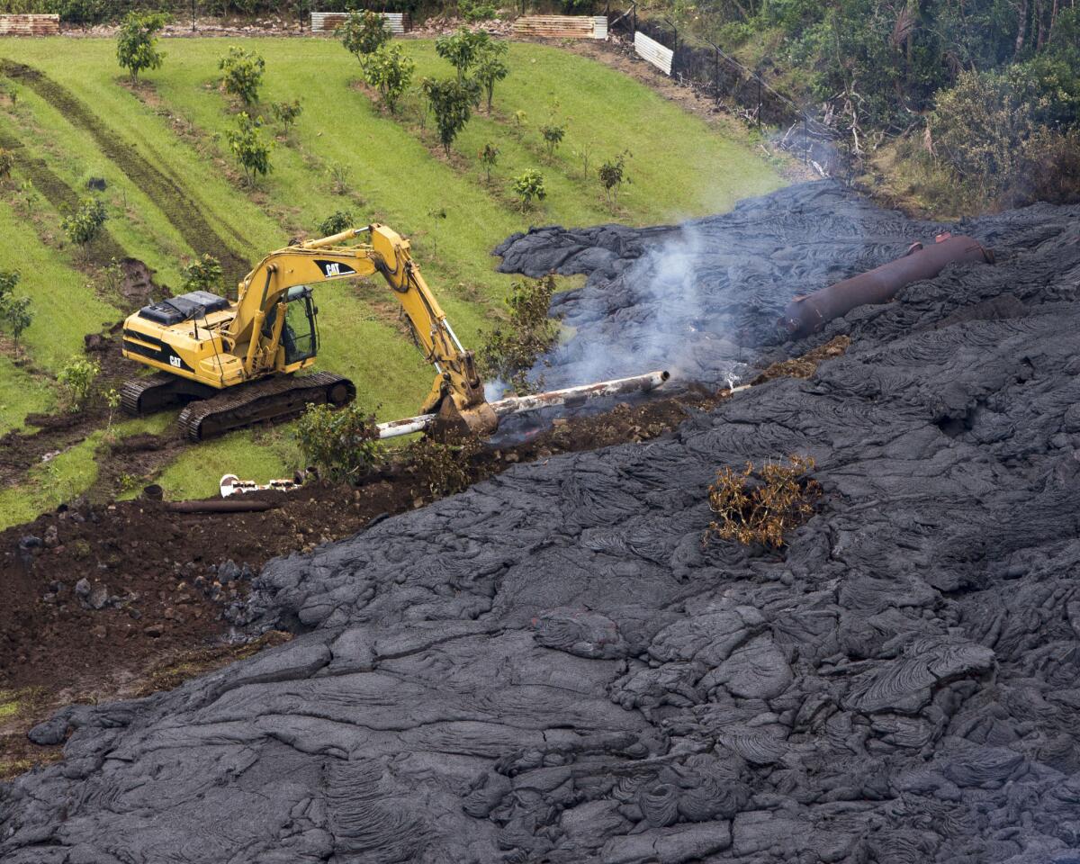 A construction crew tries to contain the lava flow from Mount Kilauea in Pahoa, Hawaii.