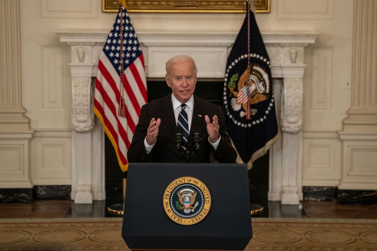 President Biden speaks at a lectern in the White House