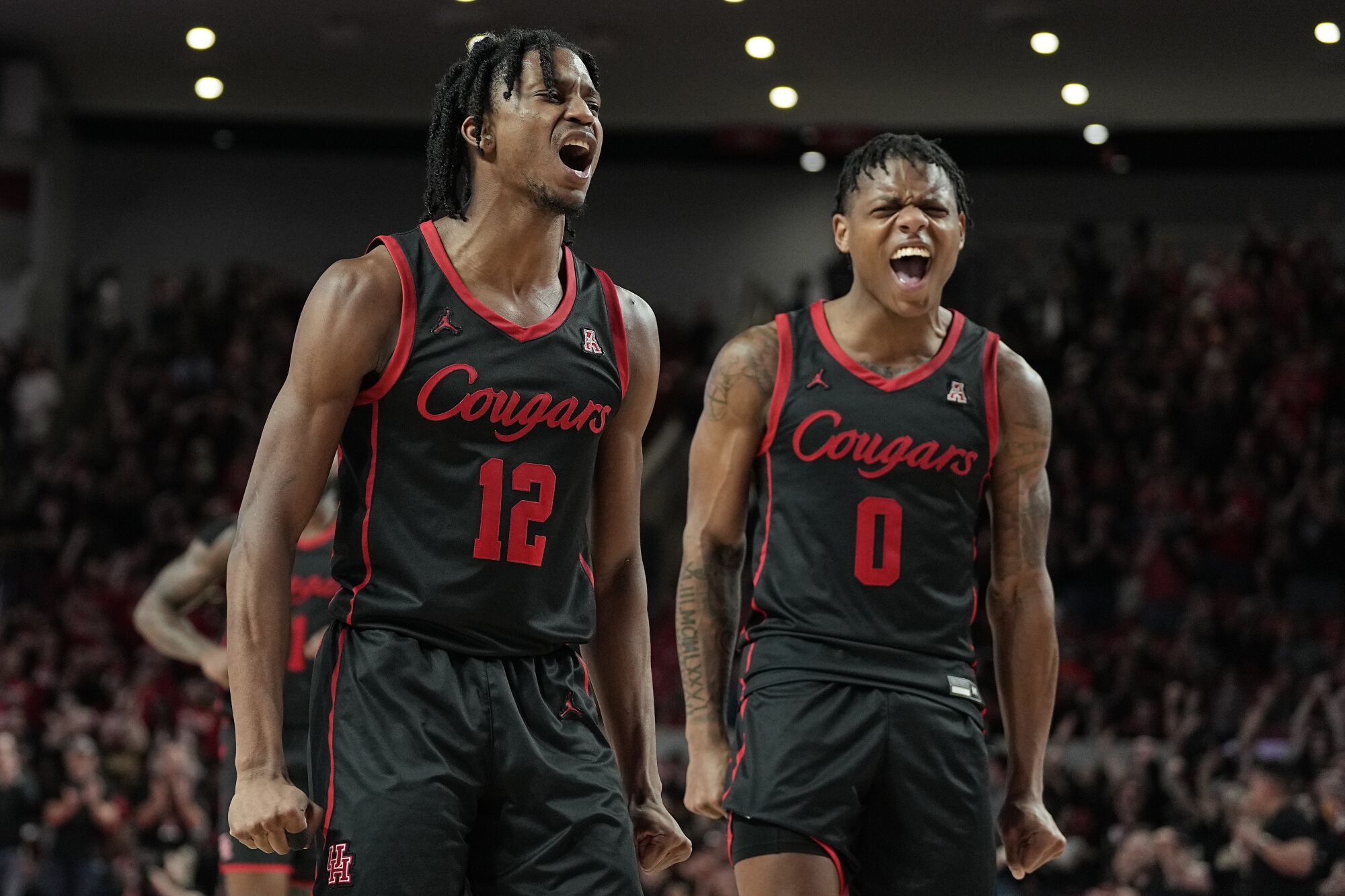 Houston guards Tramon Mark and Marcus Sasser celebrates after the Cougars scored against Tulane