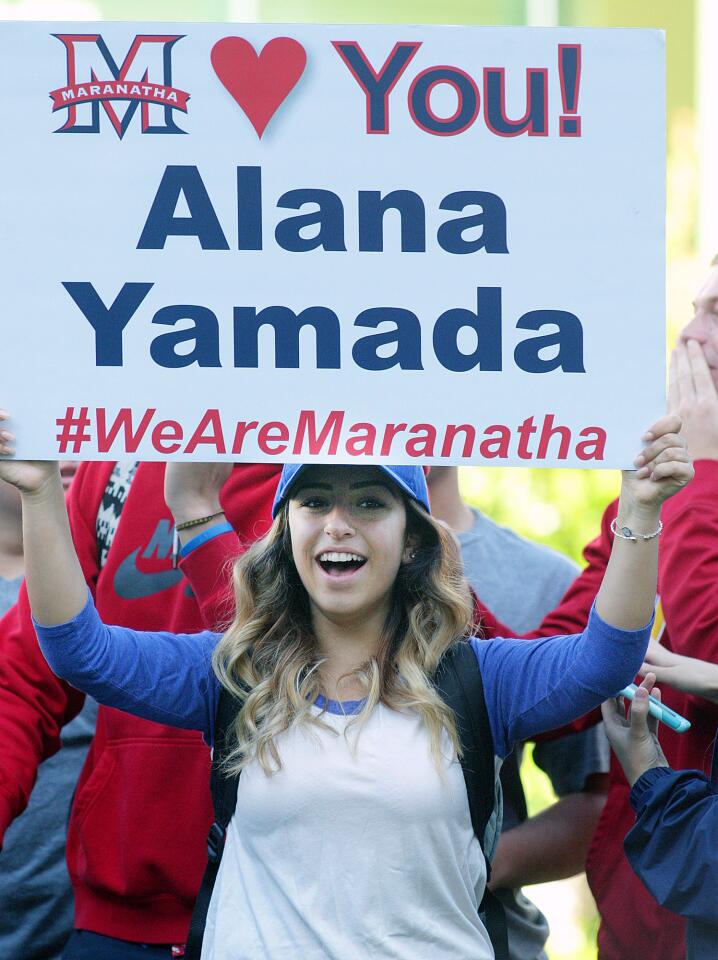 Maranatha High School student Sophia Muradian, of La Crescenta, yells out for her school holding a poster for a finalist friend at the announcement of the 2016 Tournament of Roses Royal Court at the Tournament House in Pasadena on Monday, Oct. 5, 2015.