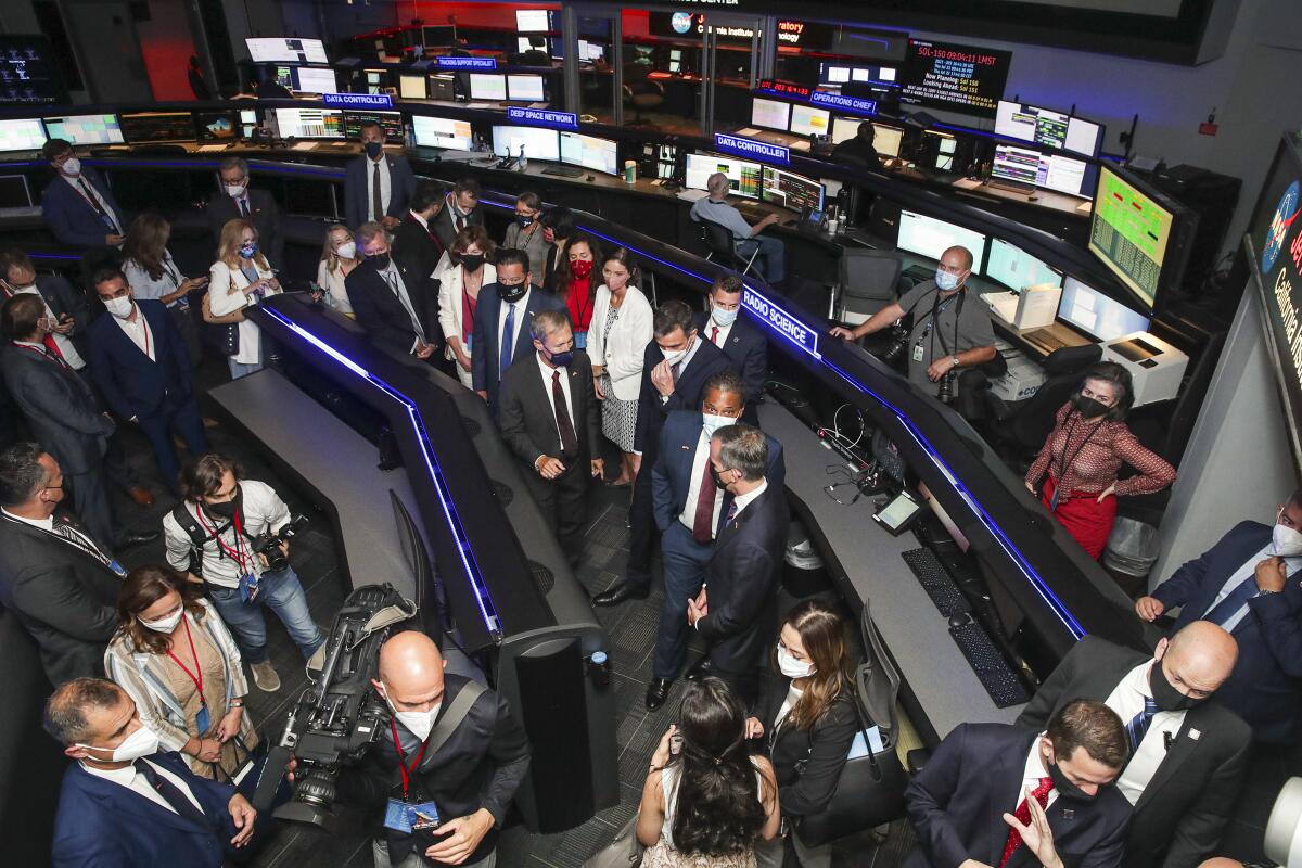 President Pedro Sanchez of Spain, center in white mask, visits mission control room at Jet Propulsion Laboratory.