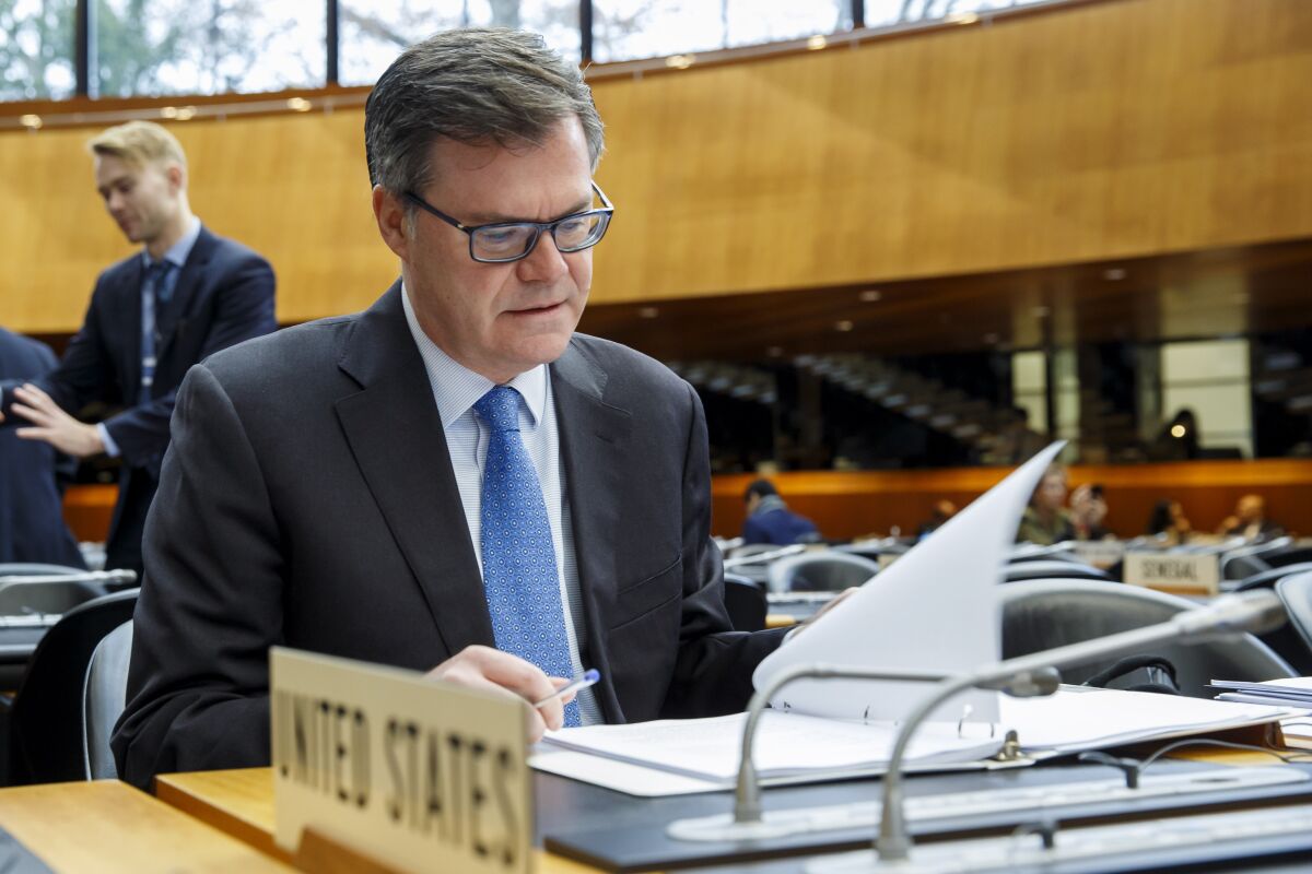 Dennis Shea, U.S. ambassador to the WTO, reads his documents prior to the opening of the World Trade Organization General Council in Geneva, Switzerland.