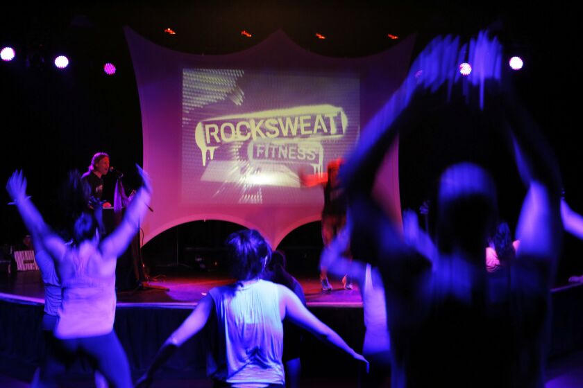 Diane Harrison teaches a class during RockSweat Fitness as participants workout at the Roxy Theatre.