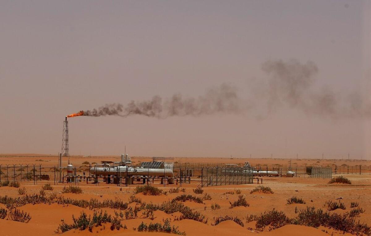 A flame from an oil pump in the Saudi desert is seen about 100 miles east of Riyadh. Oil is trading on the world market at about $50 per barrel.