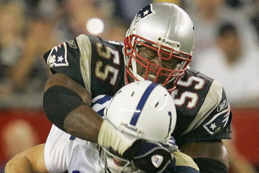 New England's Willie McGinest sacks Indianapolis' Peyton Manning in 2004.