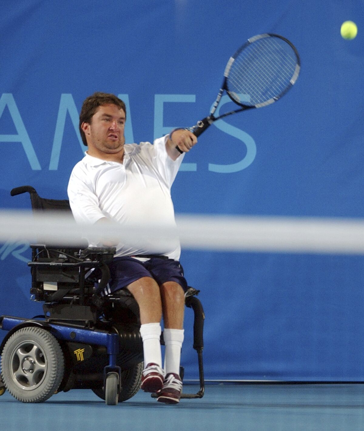 FILE - United States' Nick Taylor returns the ball to Britain's Mark Eccleston and Peter Norfolk during the men's mixed doubles - quad wheelchair tennis gold medal match at the Athens 2004 Paralympic Games in the Olympic Tennis Centre, on Sunday, Sept. 26, 2004. Three-time Paralympic wheelchair tennis champion medalist Taylor announced has his retirement. (AP Photo/Thanassis Stavrakis, File)