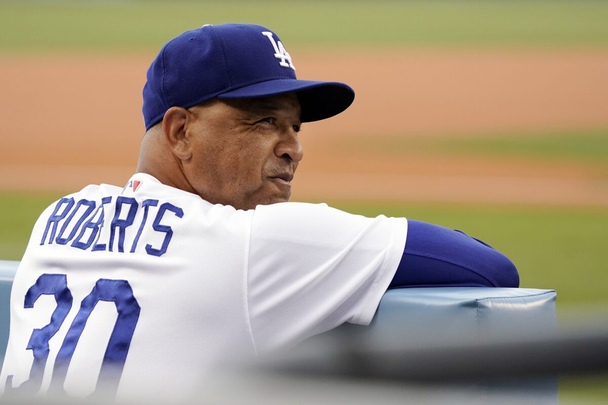 Dodgers manager Dave Roberts watches from the dugout 