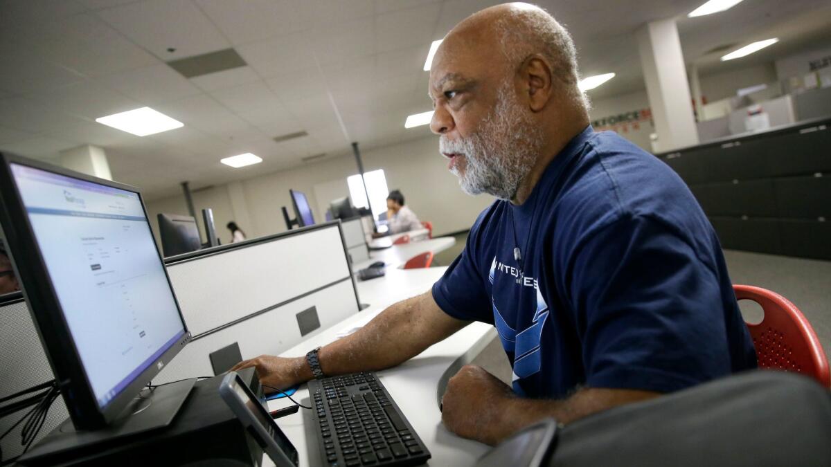 Air Force veteran Thom Brownell uses a computer to search for a job at the Texas Workforce Solutions office in Dallas on March 10.