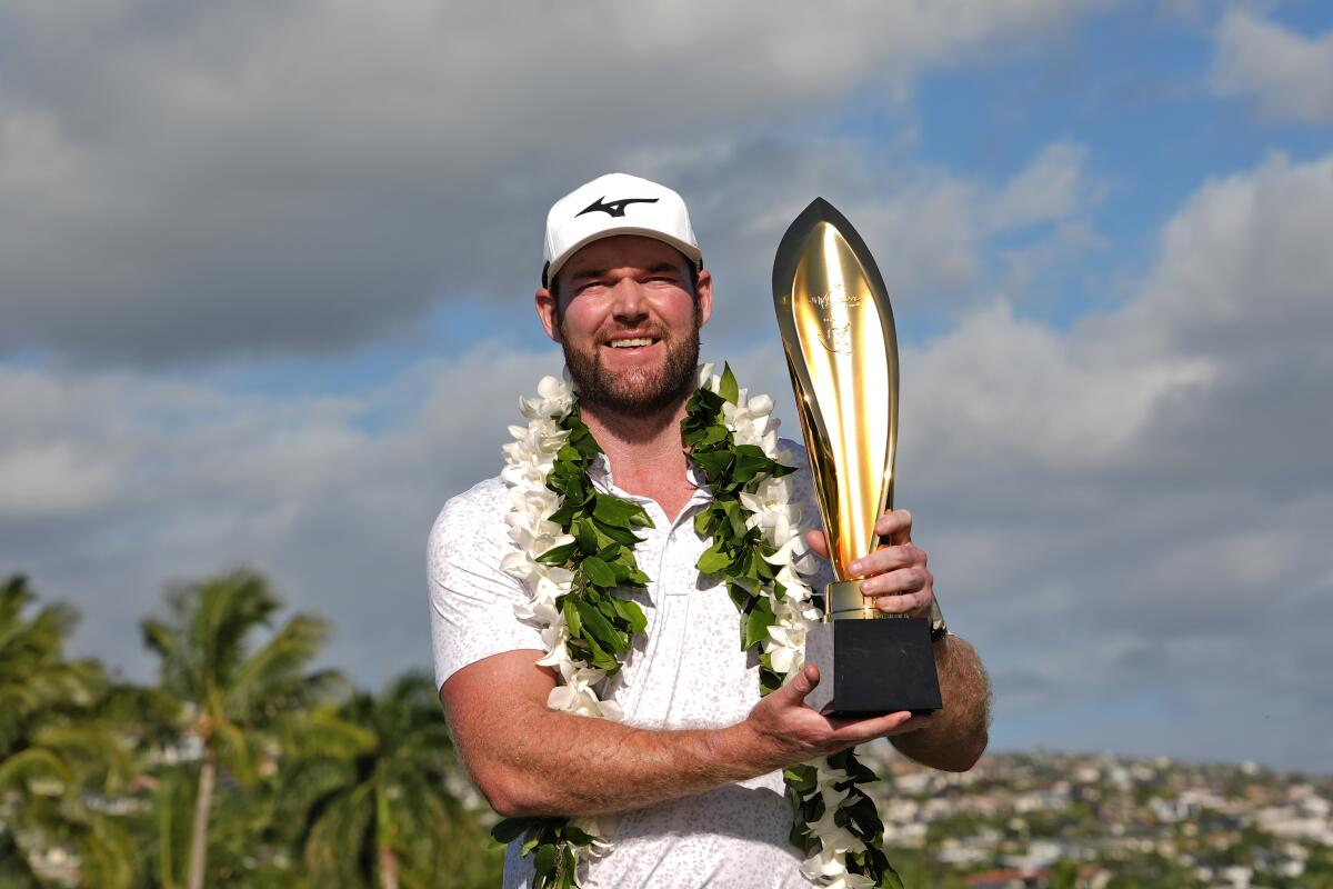 Grayson Murray holds the trophy after winning the Sony Open in Honolulu on Jan. 14.