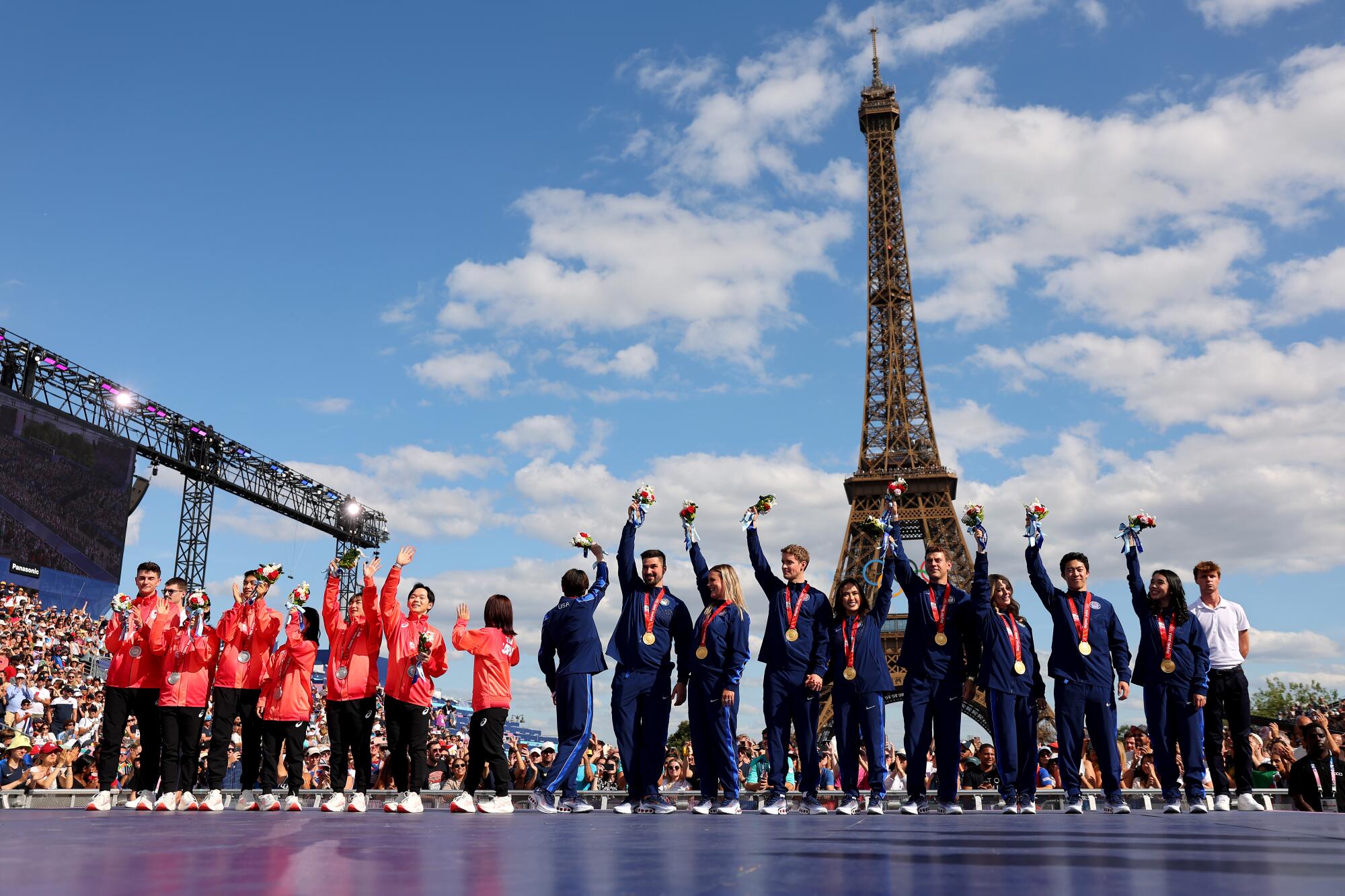 Members of the U.S. and Japan Olympic figure skating teams pose for a photo after receiving medals.