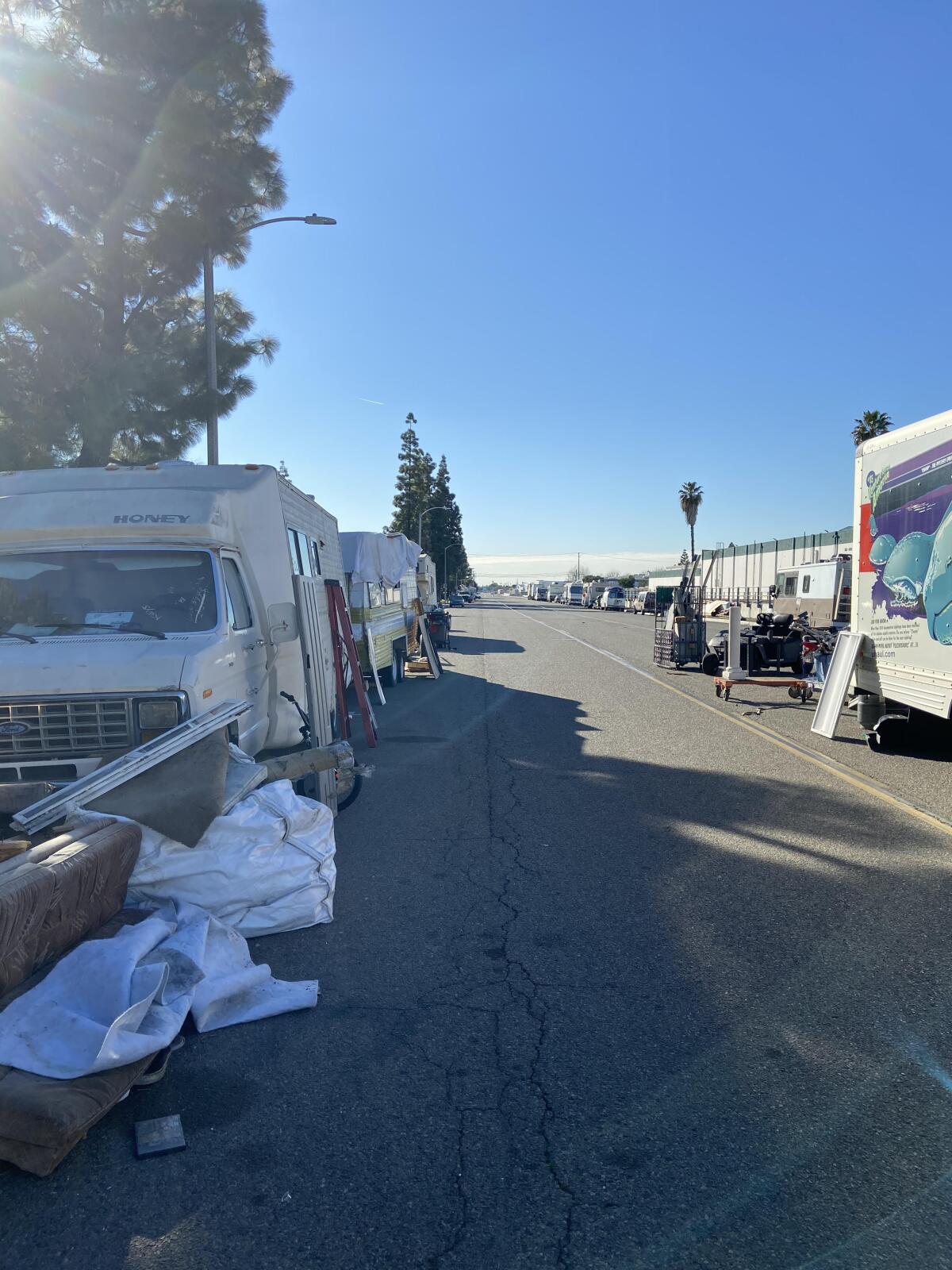 Several RVs are parked on Valencia Drive in Fullerton, where the city will begin enforcing parking restrictions.