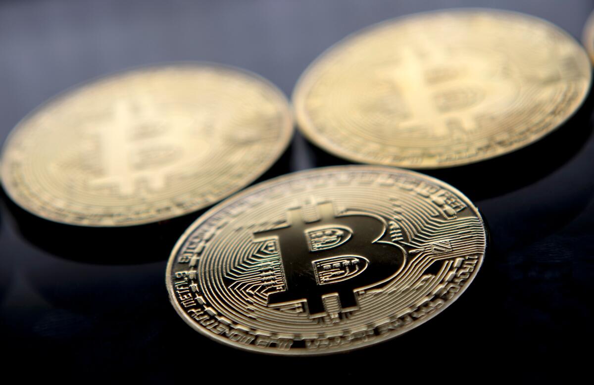 Gold coins with a "B" for Bitcoin symbol