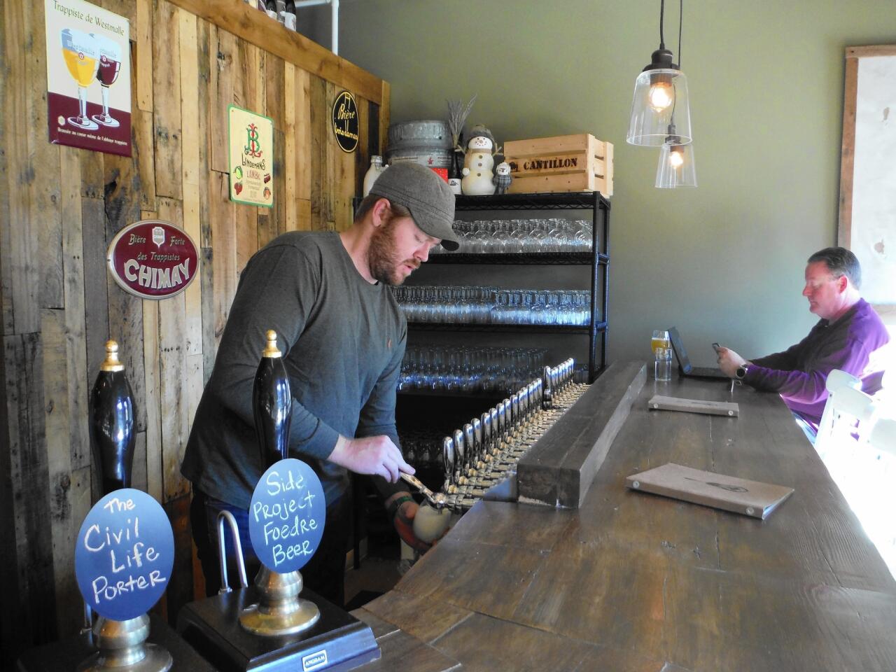Cory King, owner of Side Project Brewing, pours a beer at his bar, The Side Project Cellar in Maplewood, Mo.