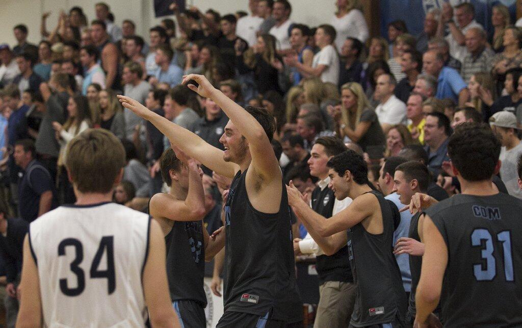 Corona del Mar High celebrates a 76-50 win over Newport Harbor during the Battle of the Bay on Saturday.