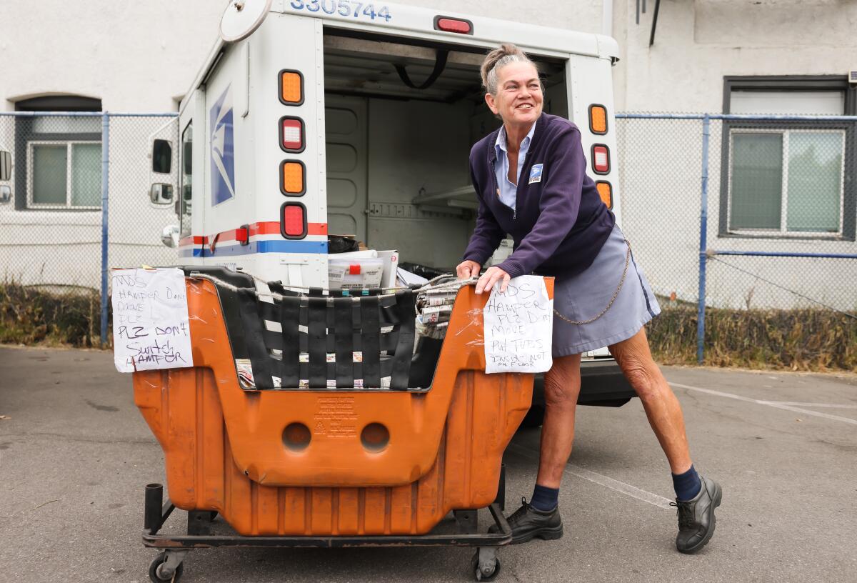 A mail carrier prepares for her route.