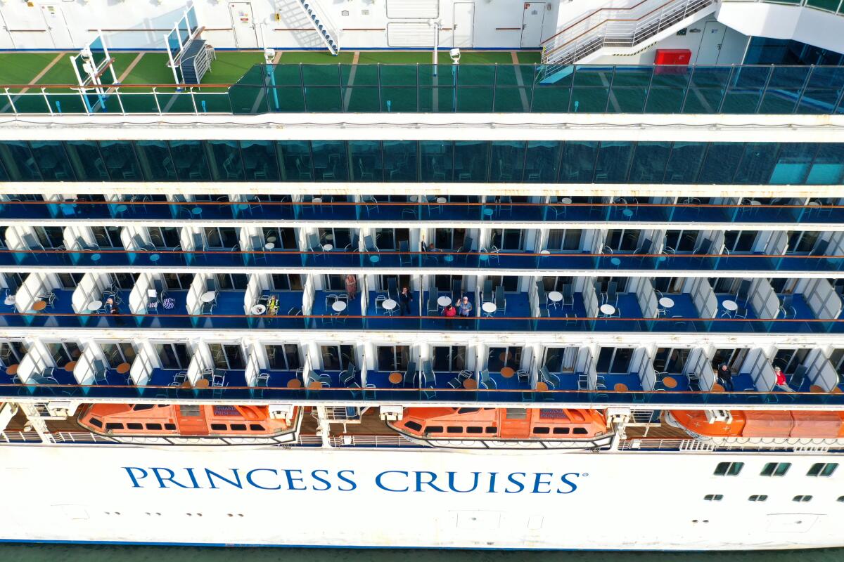 Passengers sit on the Princess Cruises Grand Princess cruise ship as it sits docked in the Port of Oakland.