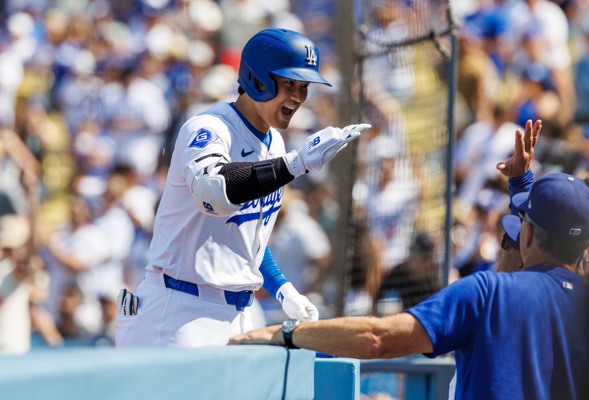 Dodgers star Shohei Ohtani celebrates with teammates after hitting a solo home run against the San Francisco Giants.