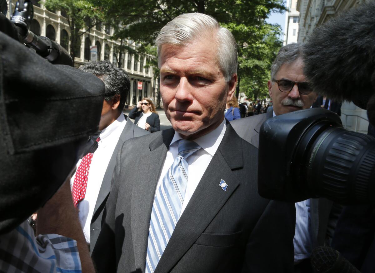 Former Virginia Gov. Bob McDonnell navigates a group of cameras as he leaves the 4th U.S. Circuit Court of Appeals after a hearing the appeal of his corruption conviction in Richmond, Va., last May.