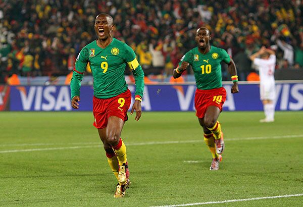 Samuel Eto'o, left, of Cameroon celebrates scoring the first goal with teammate Achille Emana during the Group E match against Denmark at Loftus Versfeld Stadium in Pretoria, South Africa, on Saturday. Cameroon lost, 2-1
