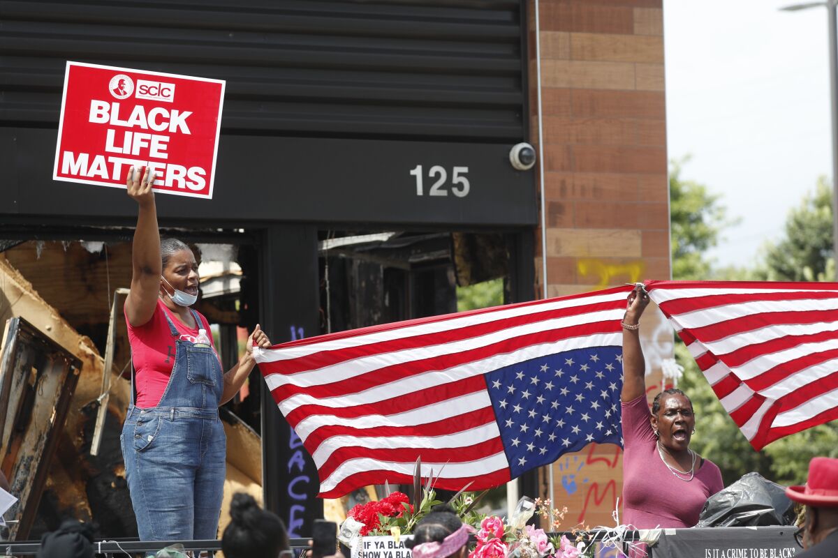 Protesters chant outside a Wendy's restaurant in Atlanta after Rayshard Brooks' funeral.