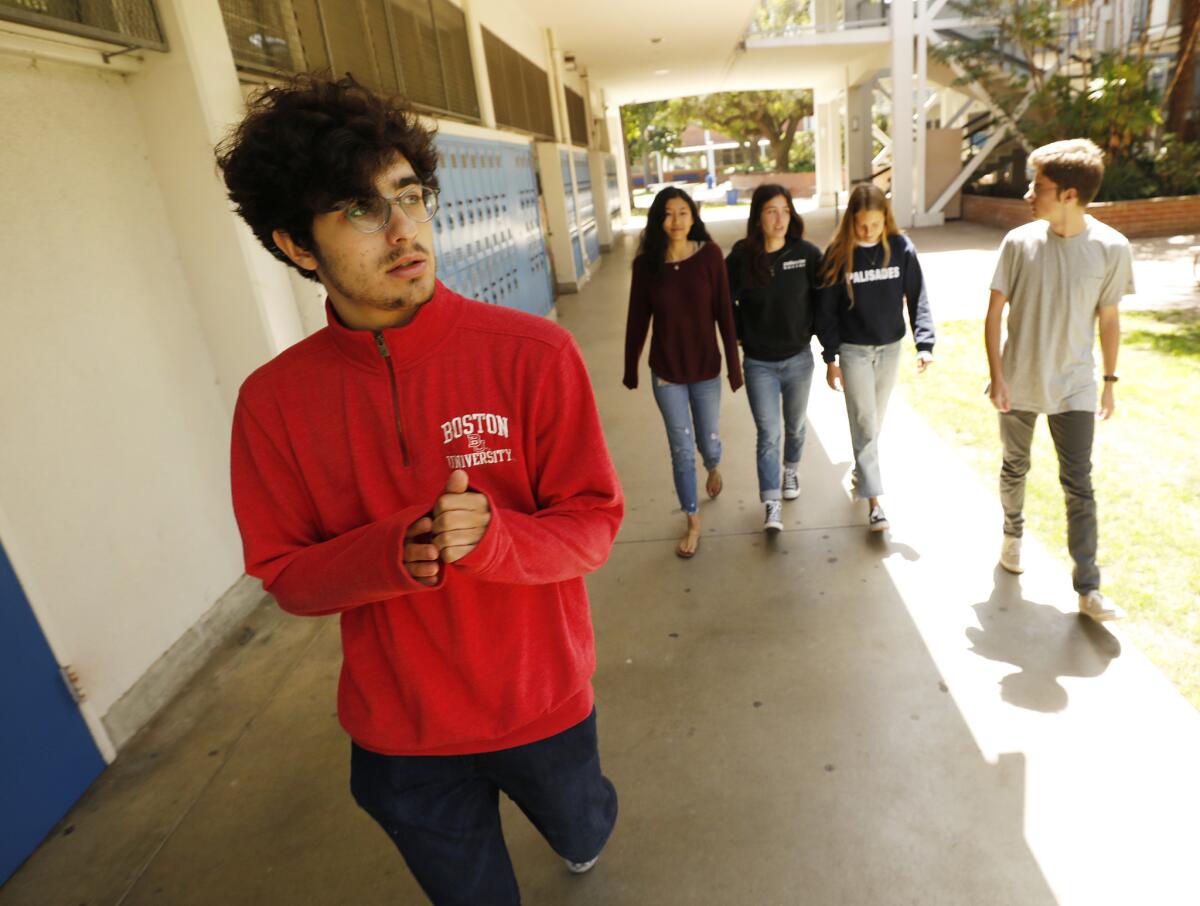 Senior Joe Meyerson, left, with fellow journalism students at Palisades Charter High School, where they are working on a series about gun violence post-Parkland.