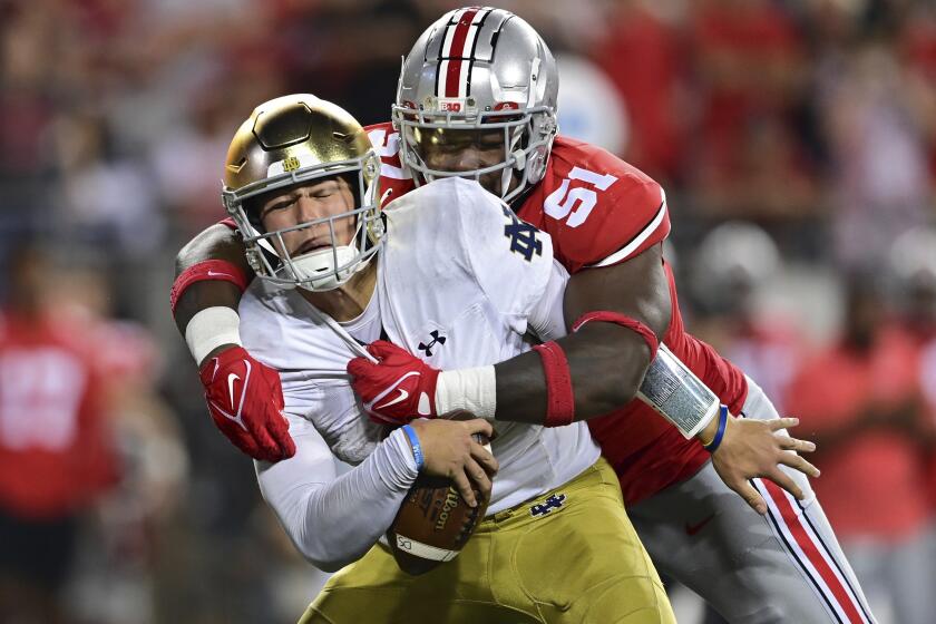 Notre Dame quarterback Tyler Buchner is sacked by Ohio State defensive tackle Michael Hall Jr. during the fourth quarter of an NCAA college football game Saturday, Sept. 3, 2022, in Columbus, Ohio. (AP Photo/David Dermer)