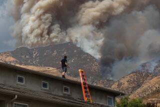 SAN BERNARDINO, CALIFORNIA - SEPTEMBER 07: A man waters the roof of his home to protect the house as the Line Fire burns in the foothills of the San Bernardino Mountains, forcing evacuations for neighborhoods on September 7, 2024 in San Bernardino, California. The fire started on Thursday afternoon and spread to more than 3900 acres as of this afternoon with zero containment. (Photo by Apu Gomes/Getty Images)