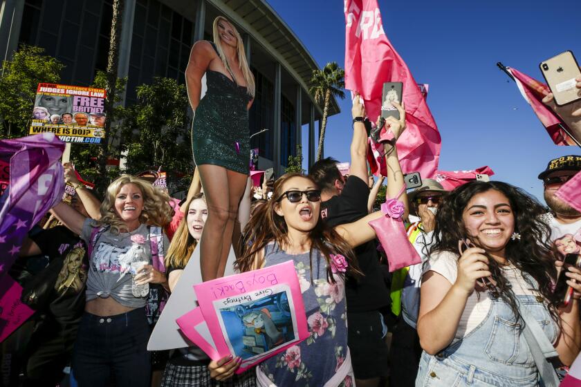 Los Angeles, CA - November 12: Free Britney supporters celebrate after hearing a Los Angeles Superior Court judge today formally has ended the conservatorship that has controlled Britney Spears' life for nearly 14 years outside Stanley Mosk Courthouse on Friday, Nov. 12, 2021 in Los Angeles, CA. (Irfan Khan / Los Angeles Times)