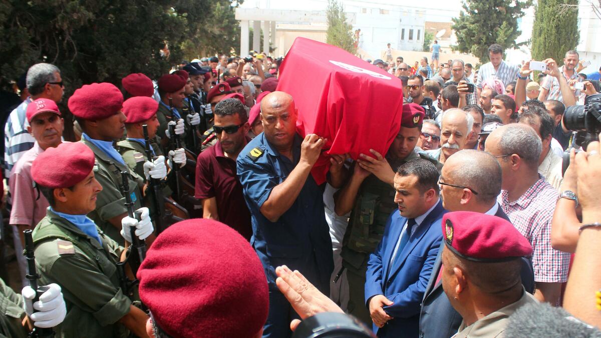 Family, friends and military officers carry the flag-draped coffin of Dr. Fathi Bayoudh, who went to Turkey to free his son from Islamic State and was killed in the suicide bombings at Istanbul's Ataturk airport.