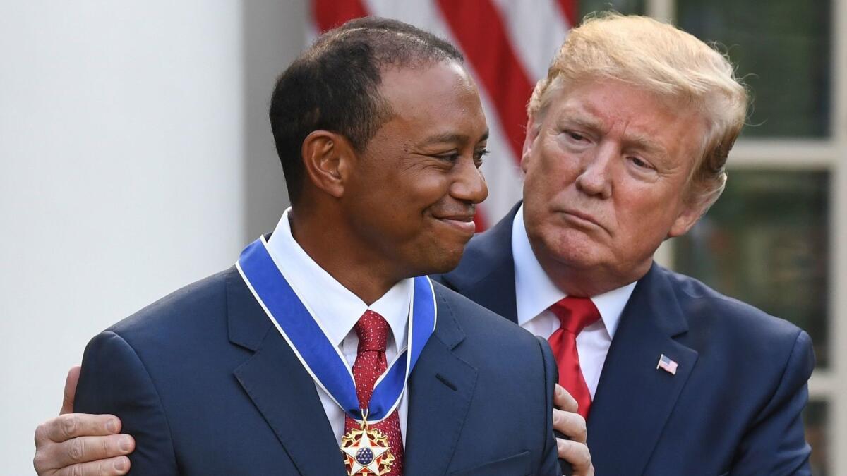 Donald Trump presents Tiger Woods with the Presidential Medal of Freedom during a ceremony in the Rose Garden of the White House on May 6.