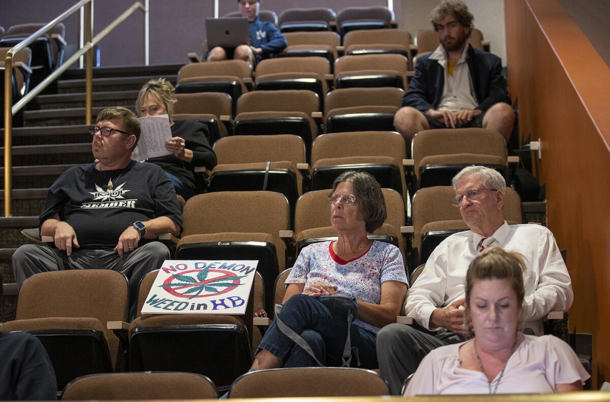 Russell Neal, right, listens during a Huntington Beach City Council study session regarding cannabis businesses.