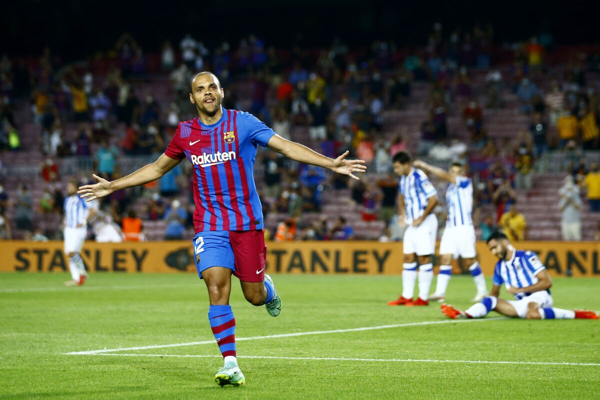 Barcelona's Martin Braithwaite celebrates after scoring his side's third goal during a Spanish La Liga soccer match between Barcelona and Real Sociedad at Camp Nou stadium in Barcelona, Spain, Sunday, Aug. 15, 2021. (AP Photo/Joan Monfort)