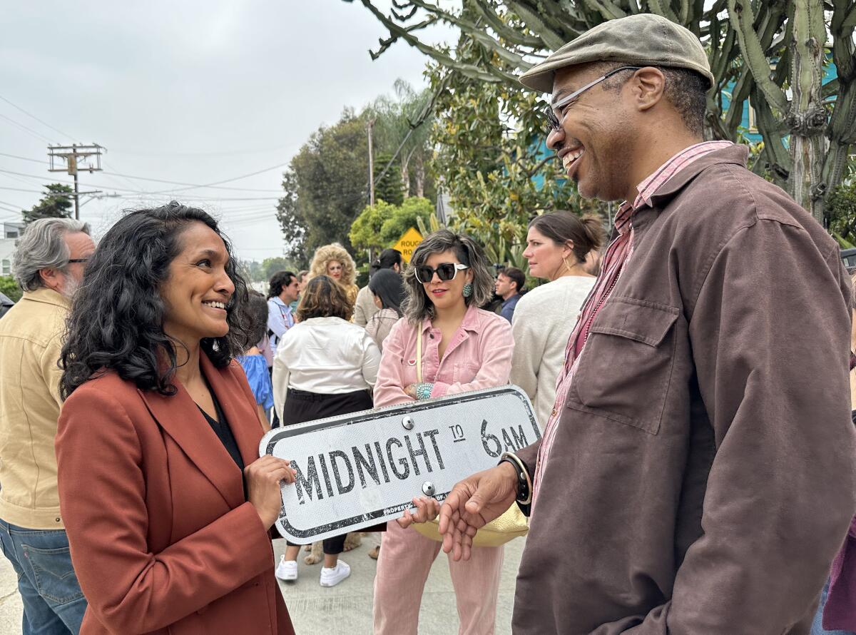 Los Angeles city councilmember Nithya Raman, left, talks with AT Center Board President Korey Wyatt (he/they).