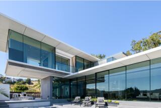 Built in 2018, the three-story home ascends to multiple decks overlooking the city.